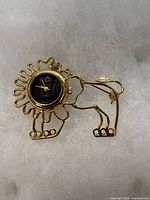Front view of lion brooch with watch
