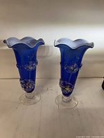 Front view of both blue hand-blown vases showing height and matching design