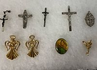 Group view of all religious pins and crosses on fabric background