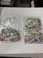 Two clear bags filled with assorted US stamps