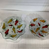 Both plates side by side showing size difference and pepper pattern