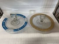 Both platters side by side showing handles and decorative rims