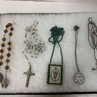 Overview of all five religious chains and beads on tray