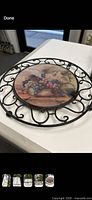 Round trivet with ceramic grape tile in black wire frame