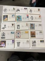 Table layout showing numerous First Day Covers with diverse cachets and postmarks.
