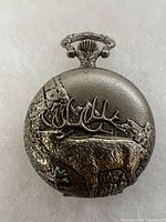 Front of pocket watch showing raised moose scene