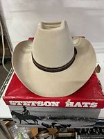 Front view of light tan Stetson cowboy hat on original box