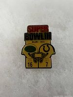 Front view of Super Bowl III pin showing design and score