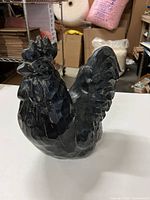 profile view of carved wooden rooster