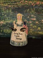 Front view showing figurine apron text and spoons