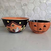 Two ceramic Halloween bowls side-by-side showing exterior designs
