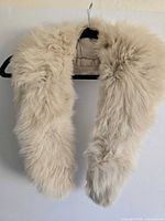 Front view of cream fur boa on hanger