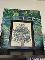 Front view of framed papyrus artwork on shelf, shows entire piece