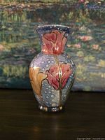 Front view showing floral design, polka-dot blue background, gilding