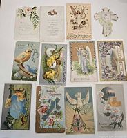 Fronts of 12 assorted embossed and flat Easter postcards laid out