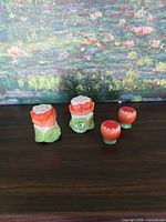 Full set of four strawberry shakers on surface