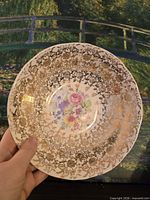 Front of Stetson porcelain bowl showing floral center and extensive gold lattice border
