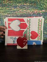Front view of card sheets and wooden heart stand
