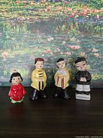 Four Japanese ceramic figurines front view