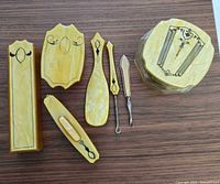 Full set laid out showing eight pieces including powder jar, boxes, brush, tools