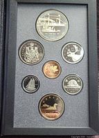 Set open showing reverse sides of seven coins