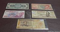 All five Banco de Mexico banknotes laid out: 1, 20, 50, 1 000, 5 000 pesos fronts visible