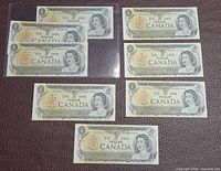All eight 1973 $1 Canadian banknotes front side