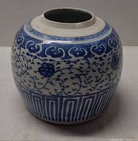 Front and side view of blue and white porcelain ginger jar showing pattern and missing lid