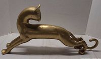 Side view of bronze cat sculpture showing overall shape