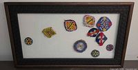 Full view of framed beaded textile collage