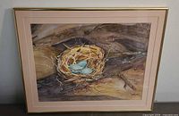 Front view of framed watercolor painting showing nest and eggs