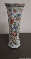 Full front view of vase showing floral motif and flared octagonal form
