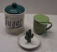 Group shot of sugar canister, infuser mug, trinket dish