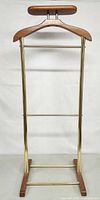 Front view of wood and brass valet stand