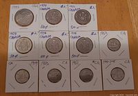 Front view of all 11 coins in 2x2 flips showing years and denominations