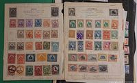 Two printed album pages labelled Haiti and Guatemala displaying multiple used stamps