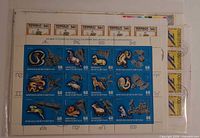 Front view showing blue 60-value animal & space sheet plus partial 50-mongo definitives and air-mail emblem sheet