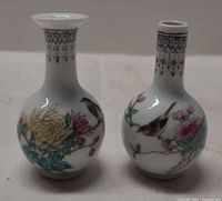 Front view showing both vases with bird and floral artwork
