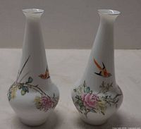 Front view of both porcelain vases showing bird and floral painting.