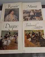 Front covers of the four portfolios showing artists' names