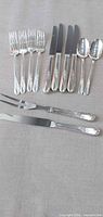 Group shot of all flatware pieces arranged on cloth