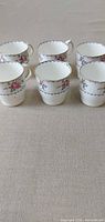 All six matching bone china mugs displayed upright