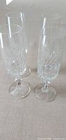 Four crystal champagne flutes on table