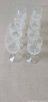 All eight crystal wine glasses lined in staggered rows