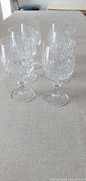 Six cut crystal goblets in a row