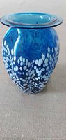 Front view of mottled blue and white blown glass vase