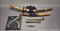 Full lot showing swords sheathed, plaque, arrowhead, two brass sceptres