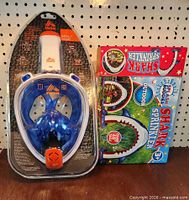 RBX snorkel mask in clamshell beside Splash Buddies shark sprinkler box