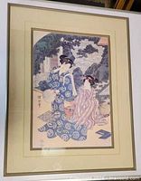 Overall view of first framed woodblock print with two women in patterned yukata, triple matting visible