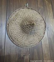 Front view of woven bamboo conical hat showing lattice weave and peak